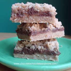 Wicked Chocolate Caramel Bars-An Oatmeal cookie Crust, gooey chocolate and caramel in the center then topped with more cookie crumbs!