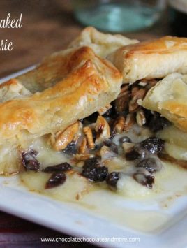 Baked Brie topped with rum soaked raisins, pecans and just a touch of maple syrup. then wrapped in a flaky puff pastry.