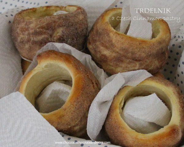 This Czech Cinnamon Pastry-Trdelnik is sold by street vendors all over Prague, A yeast dough, wrapped around a cylinder, rolled in cinnamon sugar and then baked over an open flame.