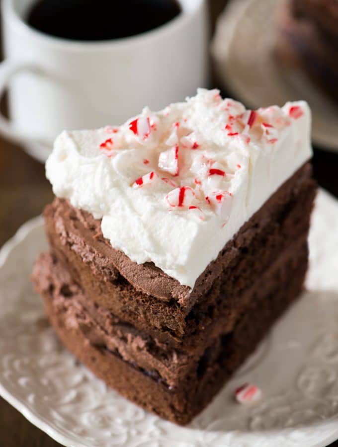 This Peppermint Mocha Cake has layers of chocolate mocha cake and chocolate peppermint frosting with peppermint whipped cream on top and of course, a sprinkle of crushed candy canes.