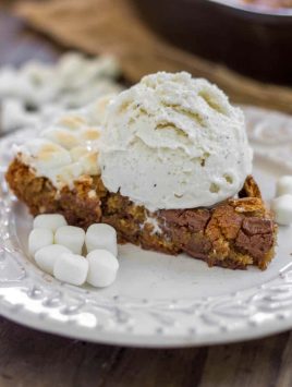 S'mores Skillet Cookie - A brown sugar cookie filled to the brim with chopped Hershey bars, marshmallows and graham crackers.