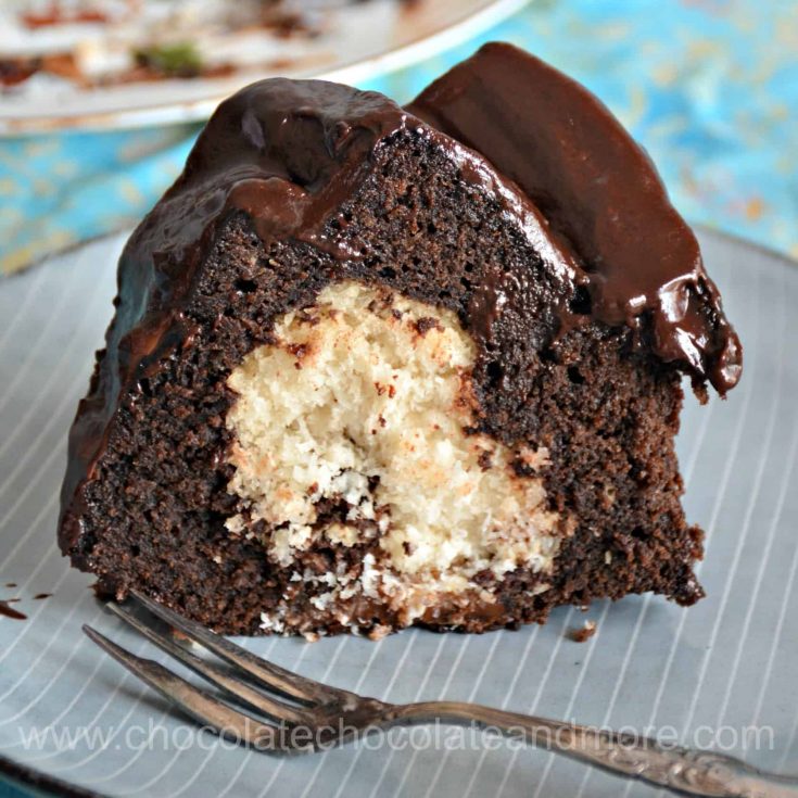 a slice of chocolate bundt cake with cream filling and topped with chocolate ganache