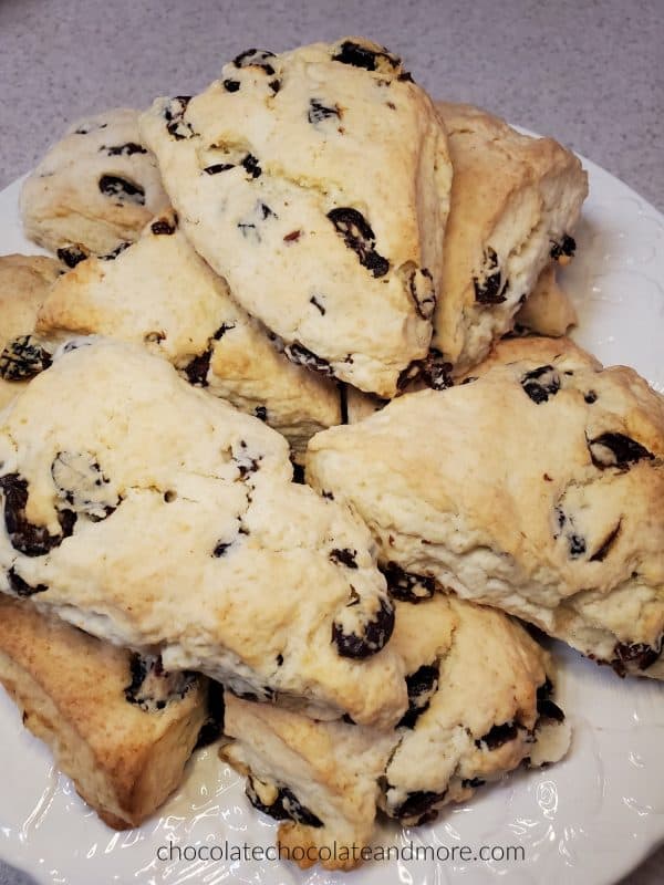 A white plate stacked with cranberry scones