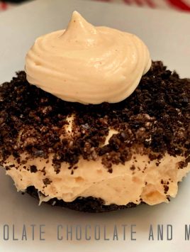 Up-close Peanut Butter Pie Cup sitting on a square white plate with red and white striped background.