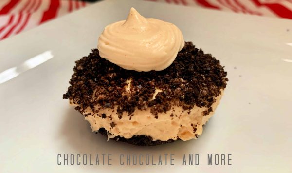 Peanut Butter Pie Cups One unwrapped peanut butter pie cup sitting on a square white plate on a red and white striped cloth.