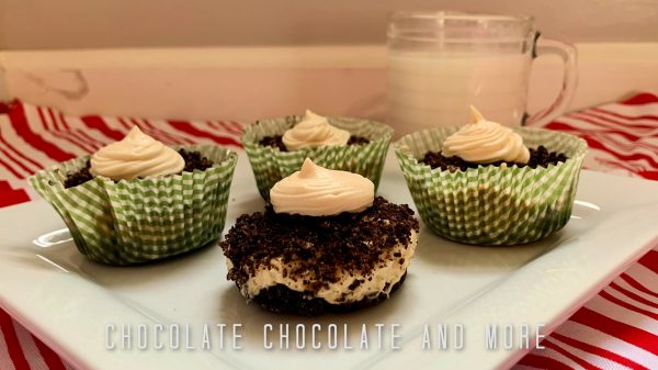 Peanut Butter Pie Cups One unwrapped and three wrapped peanut butter pie cups sitting on a white square plate and a clear mug filled with milk on a red and white striped cloth and a layered gray and white background.