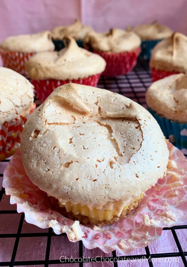 Vanilla Wafer meringue Pie Cups sitting on a metal cooling rack with a pink background.