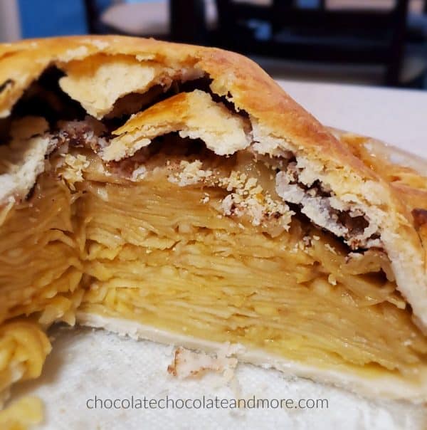 a sliced pie in a plate with layers and layers of apples