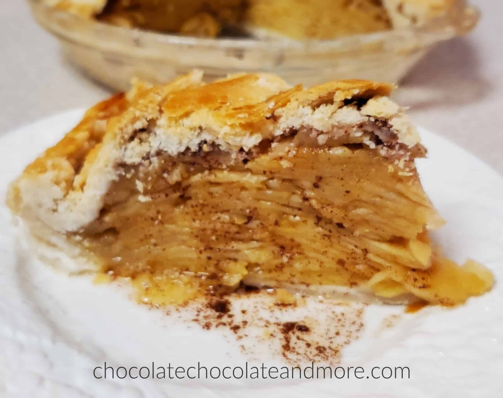 a large slice of apple pie with cinnamon dripping from the pie