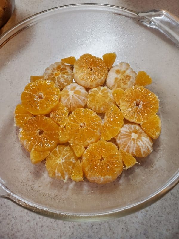 a glass dish lined with cross sections of oranges