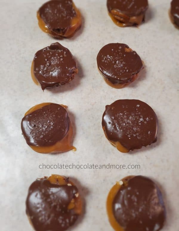 several chocolate covered caramel candies glistening with sea salt