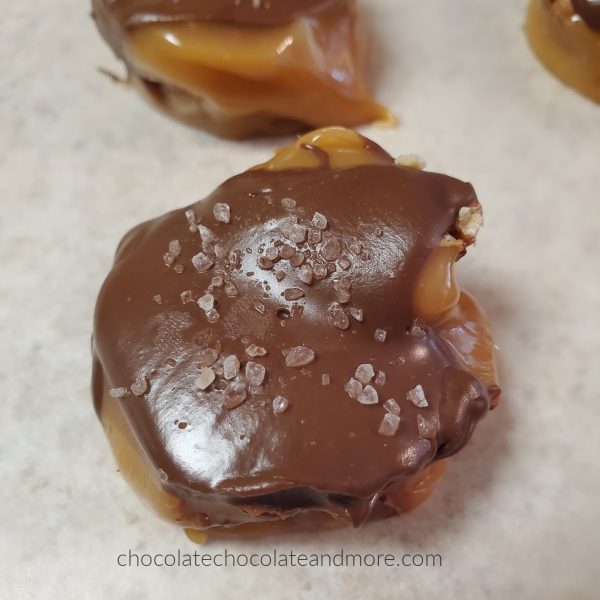 a chocolate covered piece of caramel candy with salt crystals on top