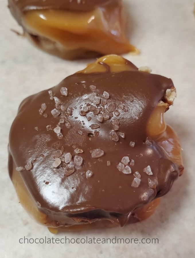 a chocolate covered piece of caramel candy with salt crystals on top