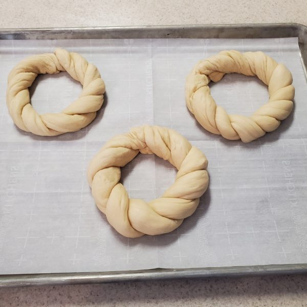 three twisted rings of raw bread dough