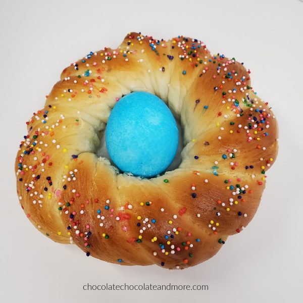 a closeup of a Easter bread braid with a blue egg in the middle