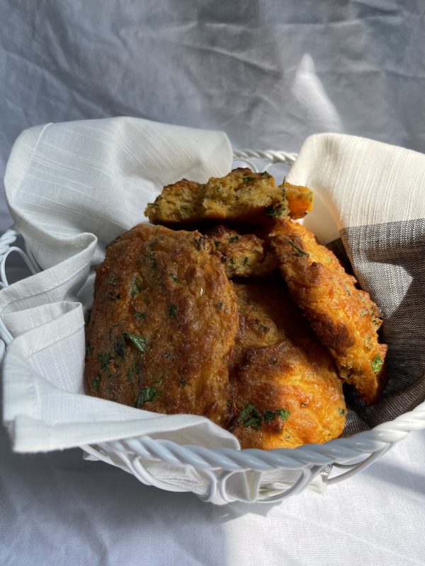 Copycat Red Lobster Cheddar Bay Biscuits Remake in a basket in front of a white background.