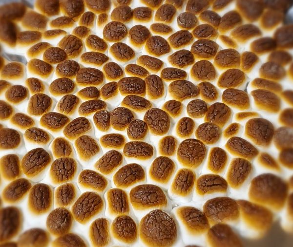 a large pan full of toasted marshmallows