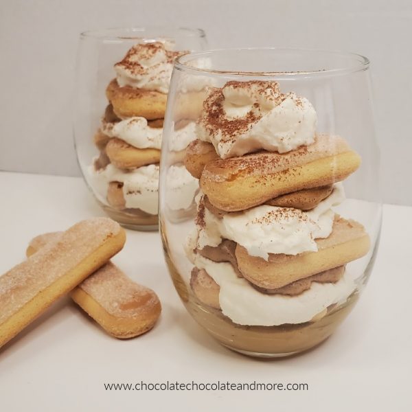 Whipped Coffee Tiramisu Parfait clear glasses filled with layers of cream filling and lady finger cookies