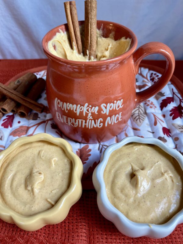 Pumpkin Spice Cheesecake Dip in an orange mug and mini pumpkin bowls filled with the dip.