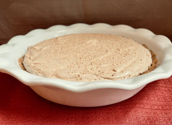 Caramel Pie Pudding sitting on a red background 