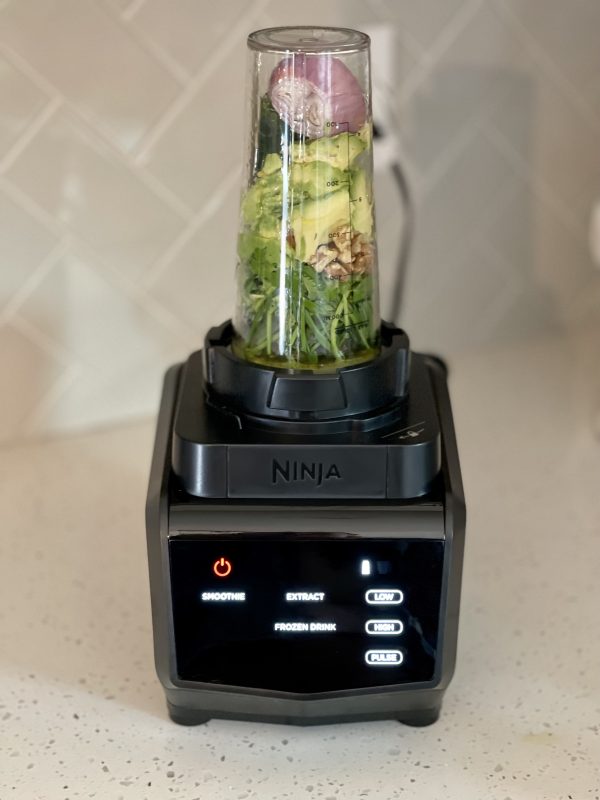 A blender filled with ingredients for dressing.