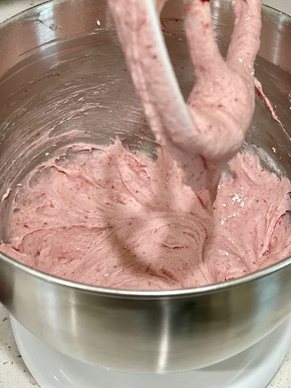 Homemade Strawberry Frosting after half of the sugar and wet ingredients have been added.
