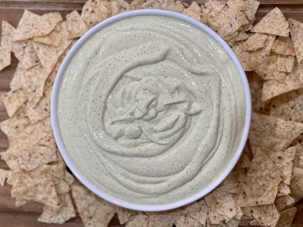 Creamy Jalapeno Dip Creamy Jalapeno Dip in a bowl with tortilla chips surrounding it on a wood cutting board