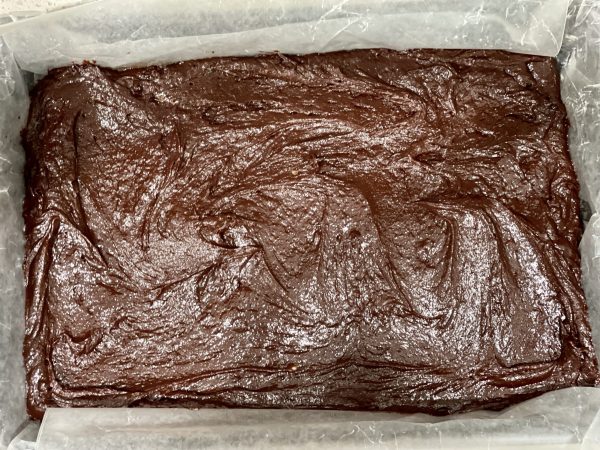 Brownie batter spread into a 9x13 pan