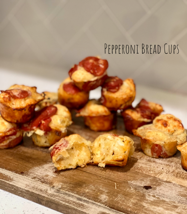 Pepperoni Bread Cups on a wood cutting board