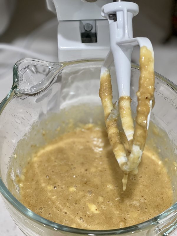 wet ingredients mixed into bananas