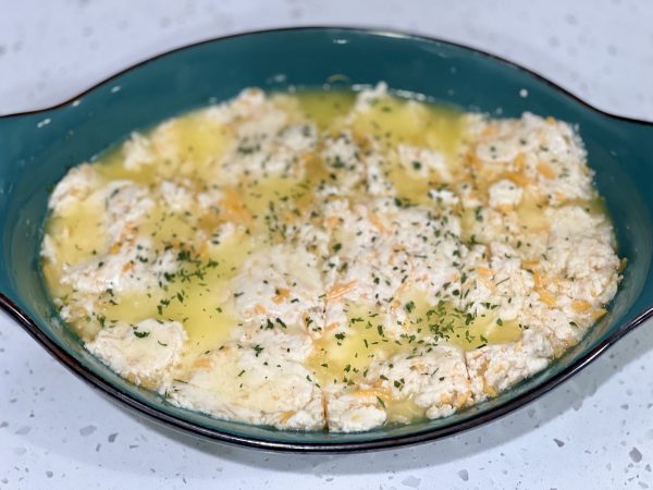 Dough spread into the butter in the baking dish