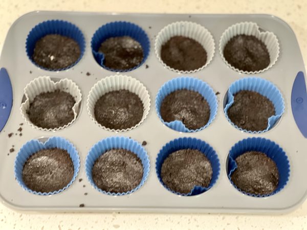 Oreo crust pressed into cupcake tray
