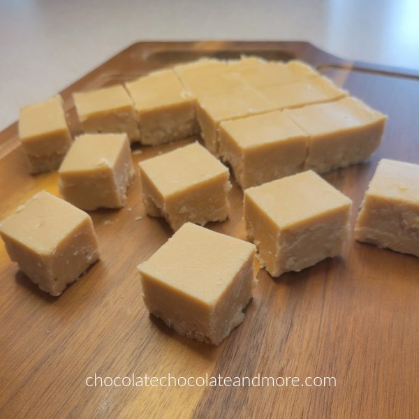 several squares of peanut butter fudge on a brown cutting board