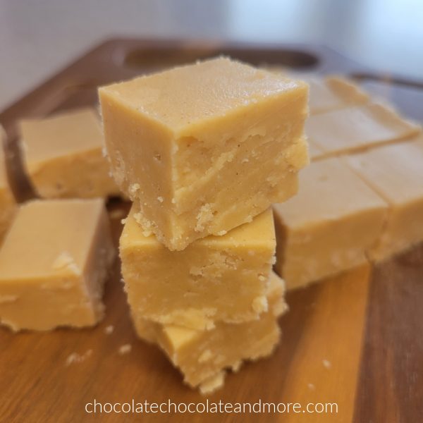 several squares of peanut butter fudge stacked up on a cutting board