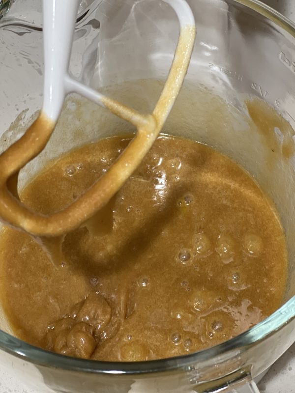 wet ingredients after being mixed in the stand mixer in a glass mixing bowl