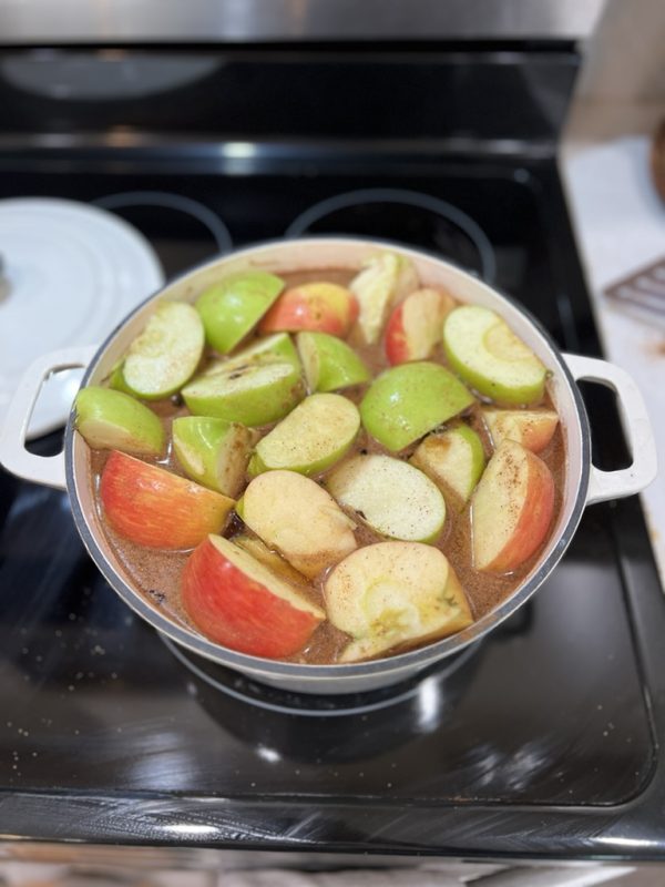 Homemade Apple Cider in a white dutch oven before cooking