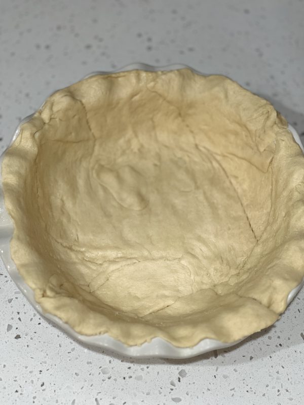 the dough spread into the bottom of the pie plate