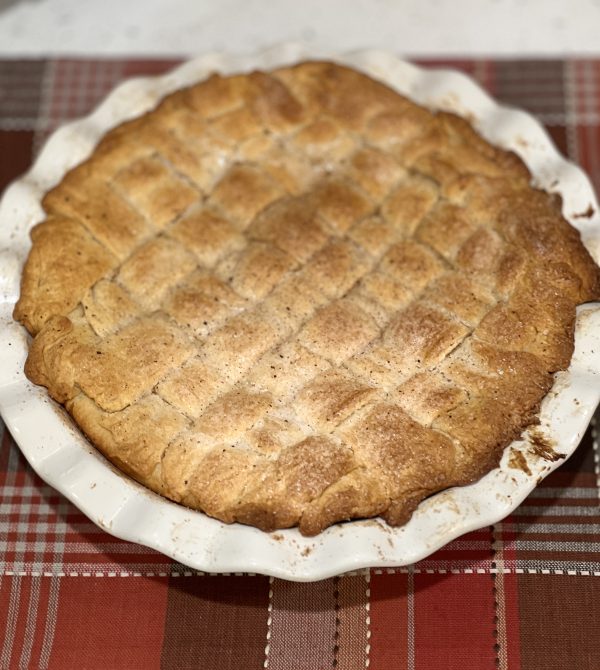 Sugar Cream Crescent Pie after baking on a plaid table setting
