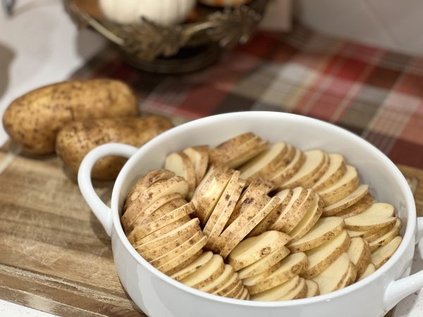 potatoes sliced and arranged in the baking dish