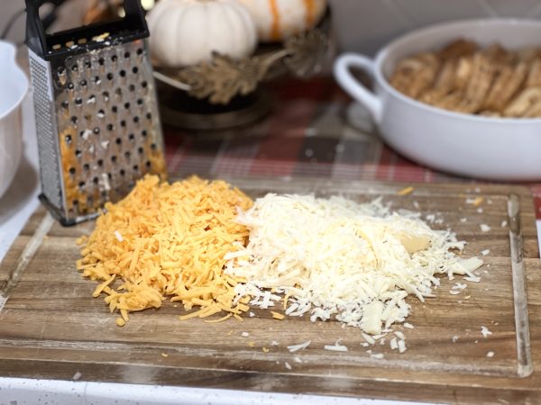 freshly grated cheese on a wood cutting board
