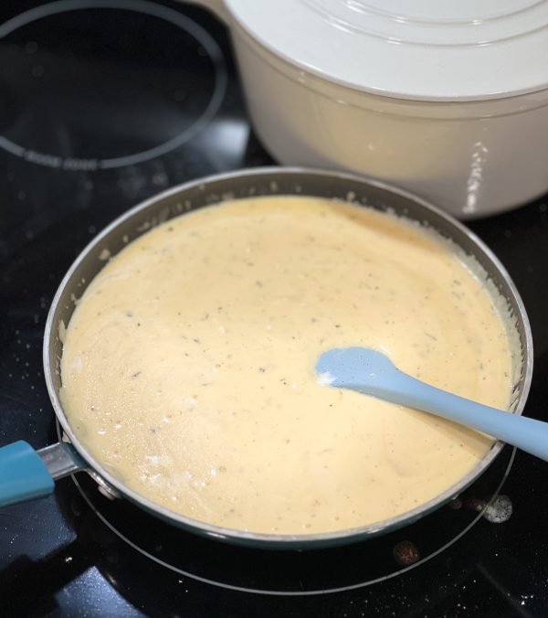 cheesy sauce on a stove 