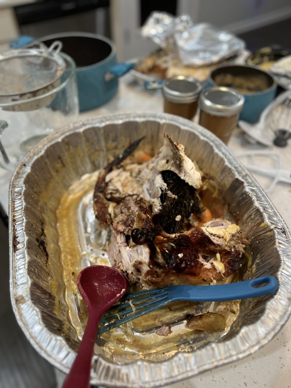 Leftover turkey carcass in an aluminum pan