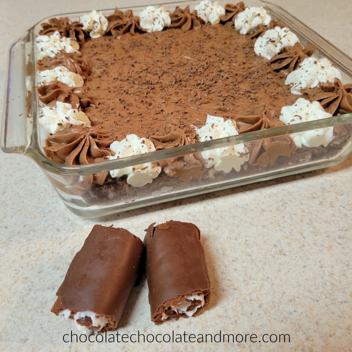 a glass dish filled with swiss roll slices and filled with chocolate mousse