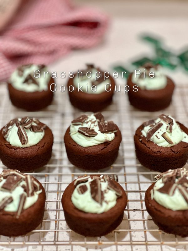 Grasshopper Pie Cookie Cups on a metal cooling rack in front of a red towel