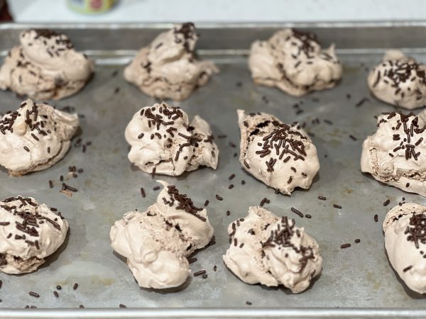 Hot Cocoa Meringue Cookies after baking on a cookie sheet