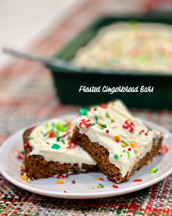 Frosted Gingerbread Bars on a white plate on a christmas table runner