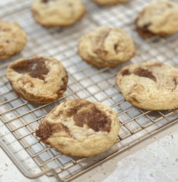 Cinnamon Roll Sugar Cookies on a cooling rack