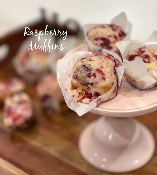 Raspberry Muffins sitting on a pink cake stand 