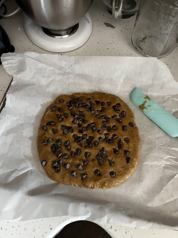 Chewy Chocolate Chip Cookie Cake dough ona cookie sheet before baking